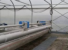 On its way back the sludge turner can drop the dry sludge into a screw that is installed below ground level.